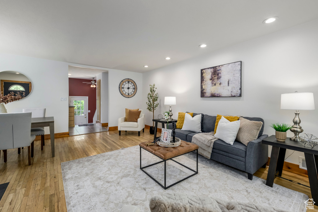 Living room with light wood-type flooring, recessed lighting, and a ceiling fan
