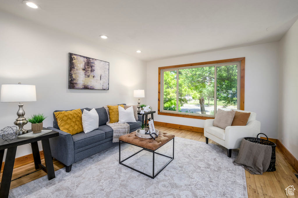 Living area featuring light wood-style floors and recessed lighting
