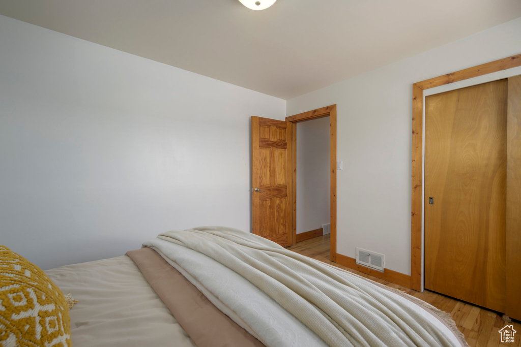 Bedroom with light wood-type flooring and baseboards