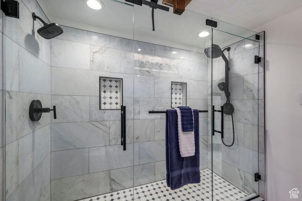 Bathroom with a stall shower and recessed lighting