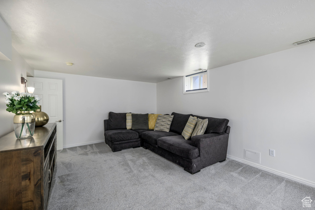 Carpeted living room featuring baseboards