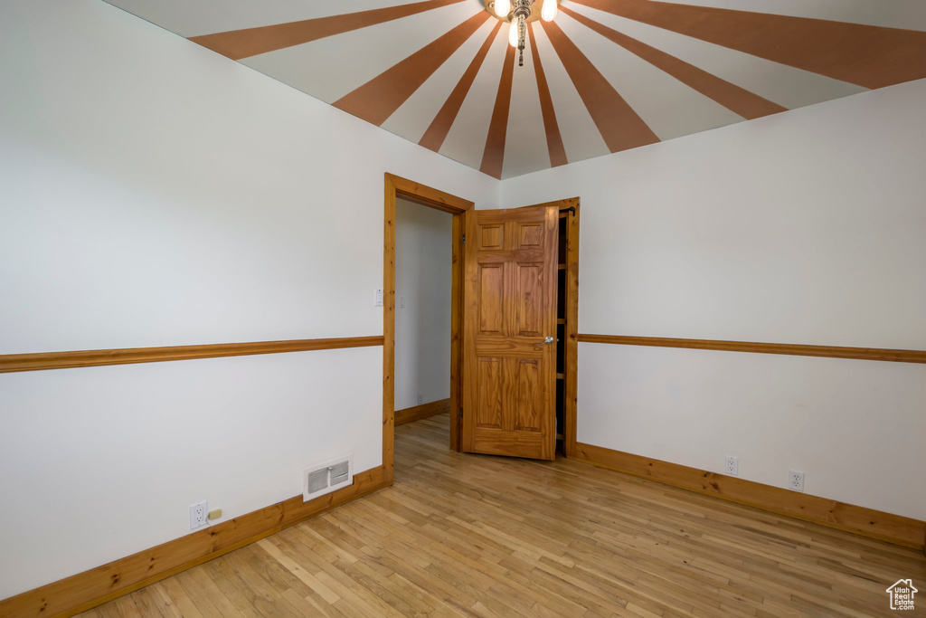 Unfurnished room featuring baseboards and light wood-type flooring