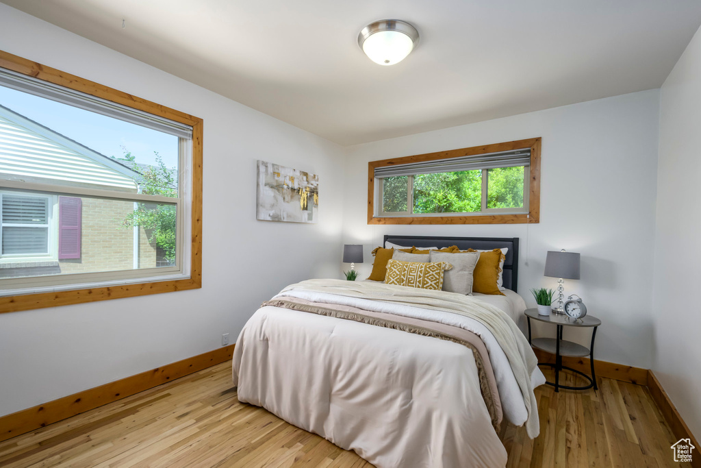 Bedroom with baseboards and wood finished floors