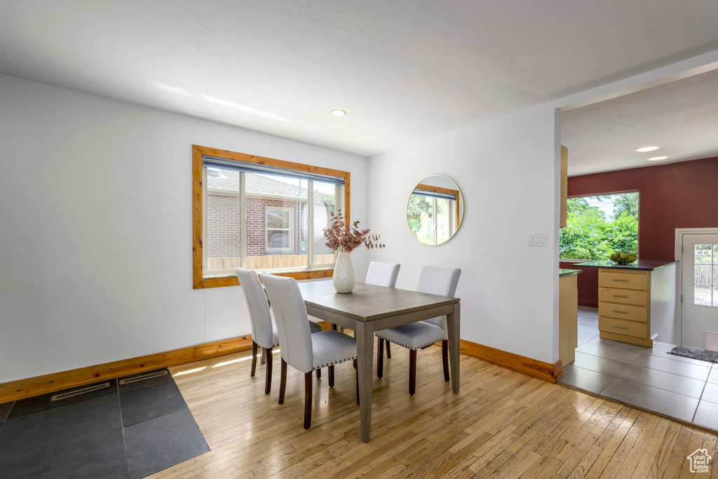 Dining space with light wood-type flooring, plenty of natural light, and recessed lighting