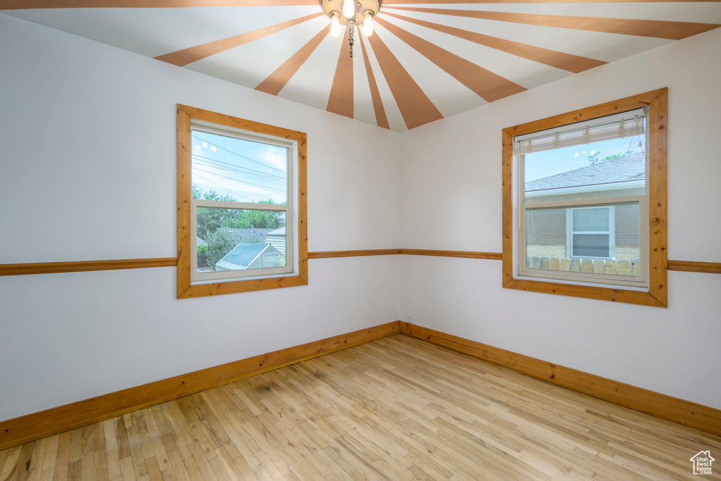 Unfurnished room with plenty of natural light and light wood-style flooring