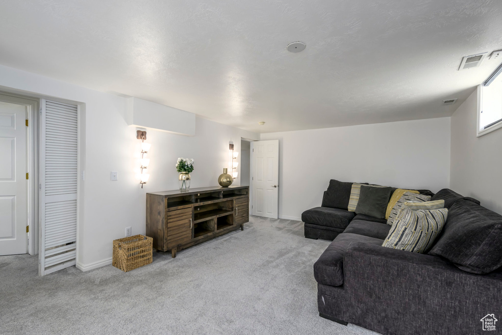 Carpeted living area featuring baseboards