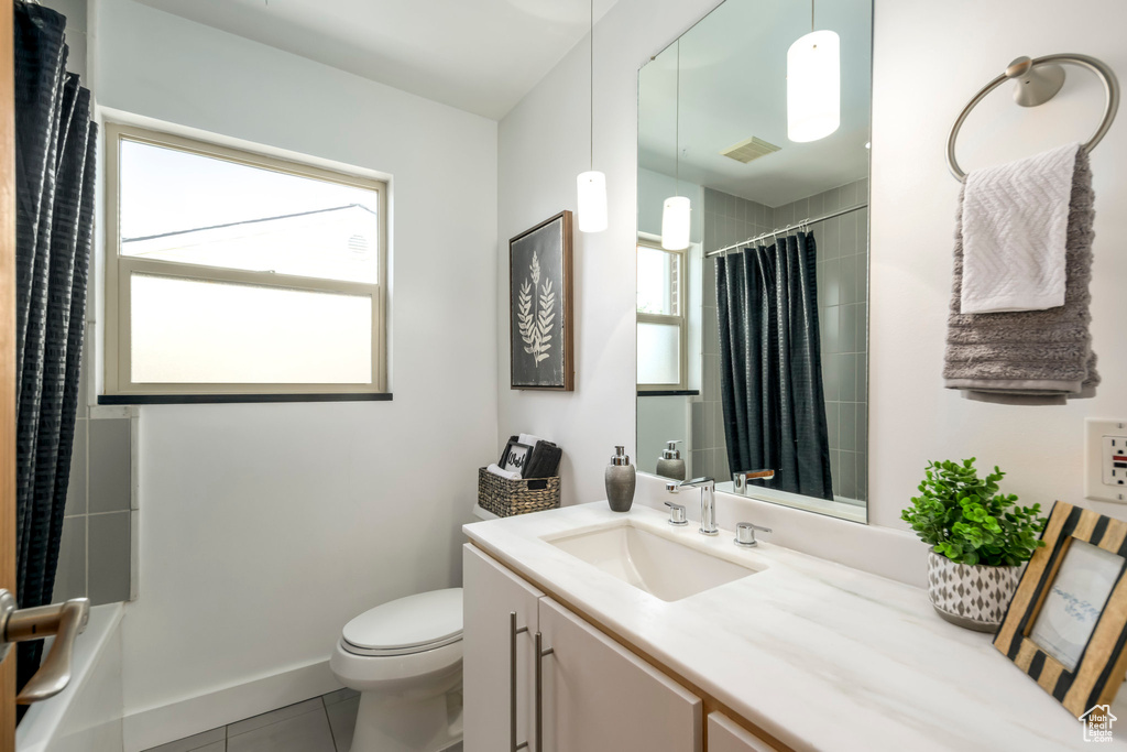 Bathroom featuring vanity, tile patterned floors, and shower / bath combo