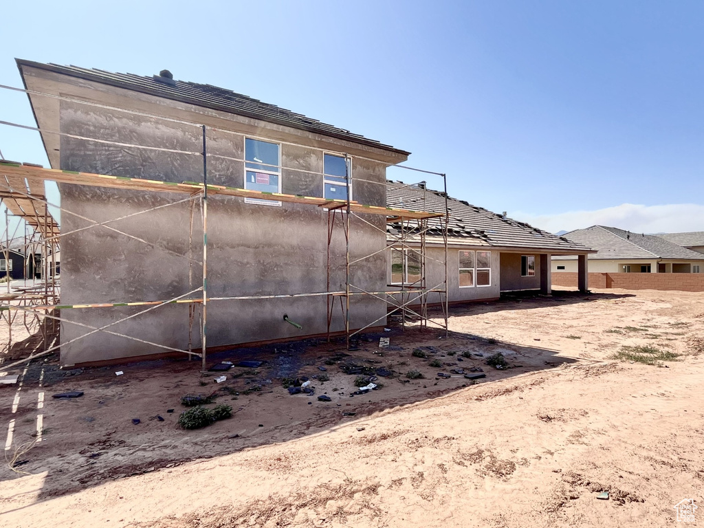 Back of house featuring stucco siding