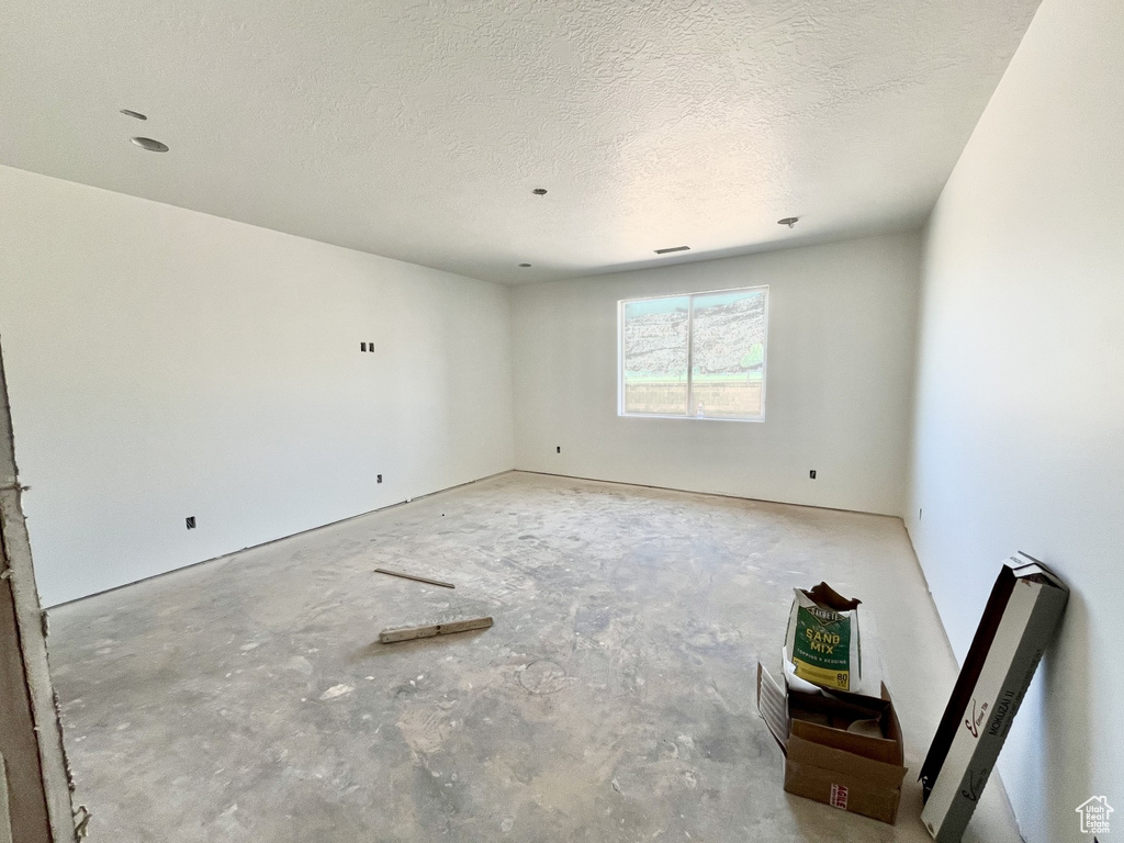 Empty room featuring a textured ceiling