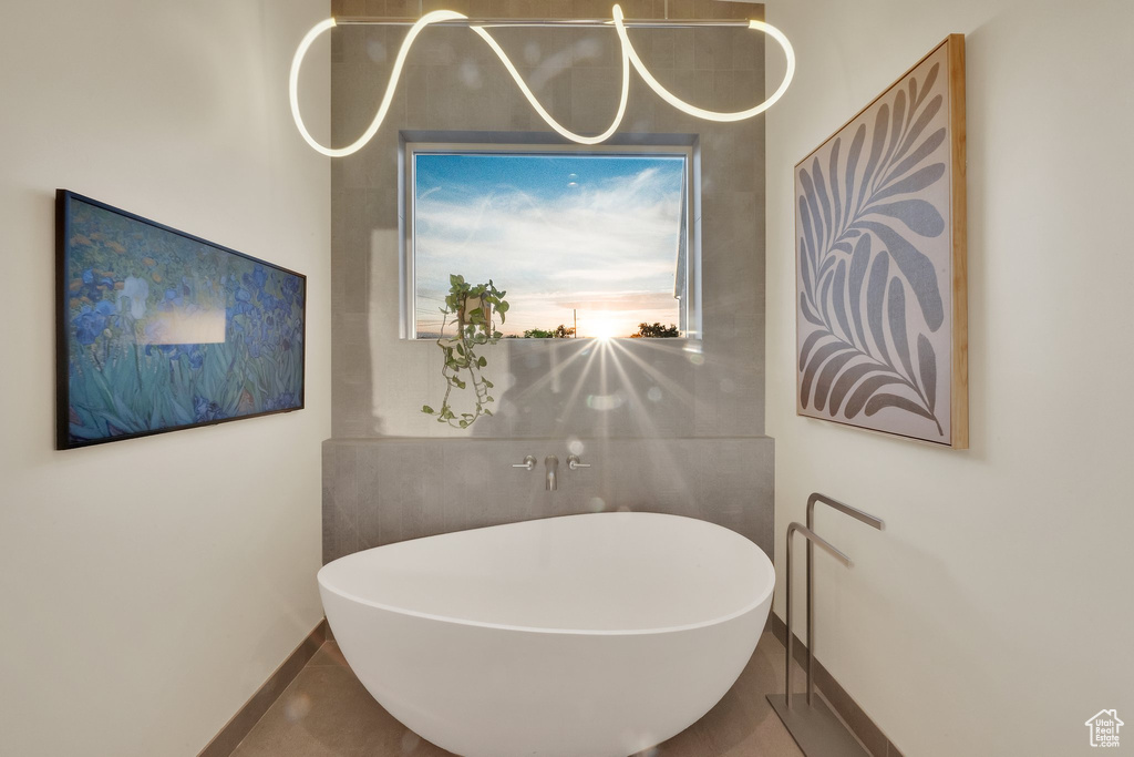 Bathroom featuring a freestanding bath and baseboards