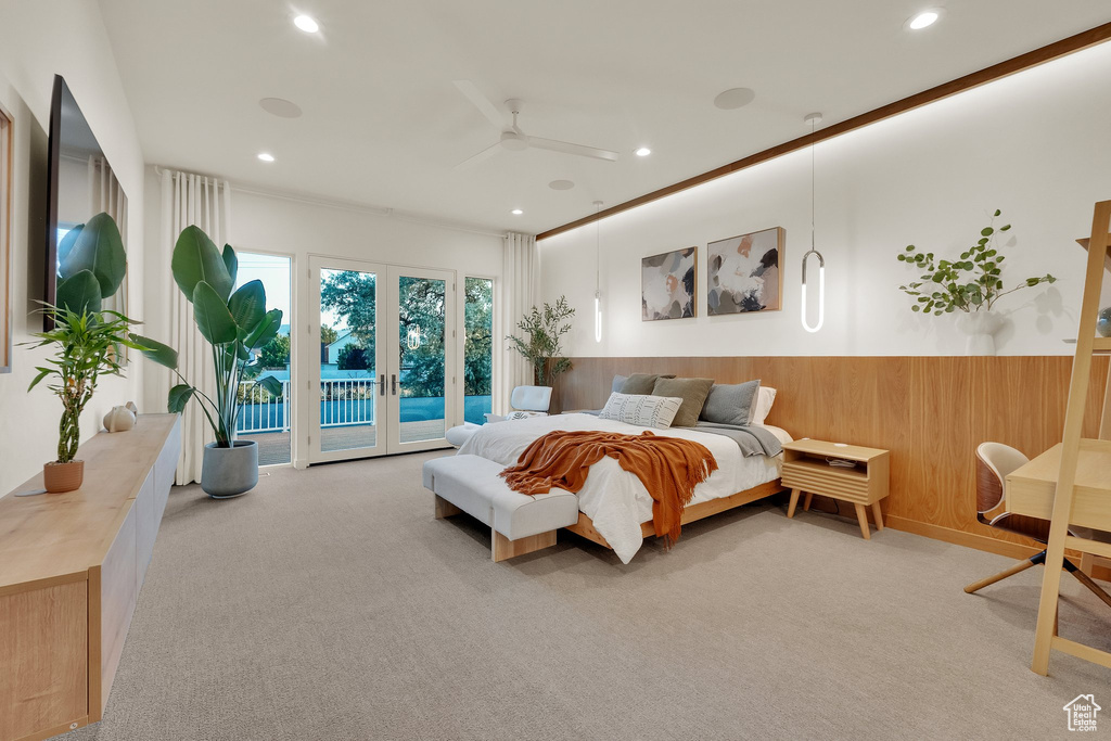 Carpeted bedroom featuring access to outside, a wainscoted wall, wood walls, recessed lighting, and ceiling fan