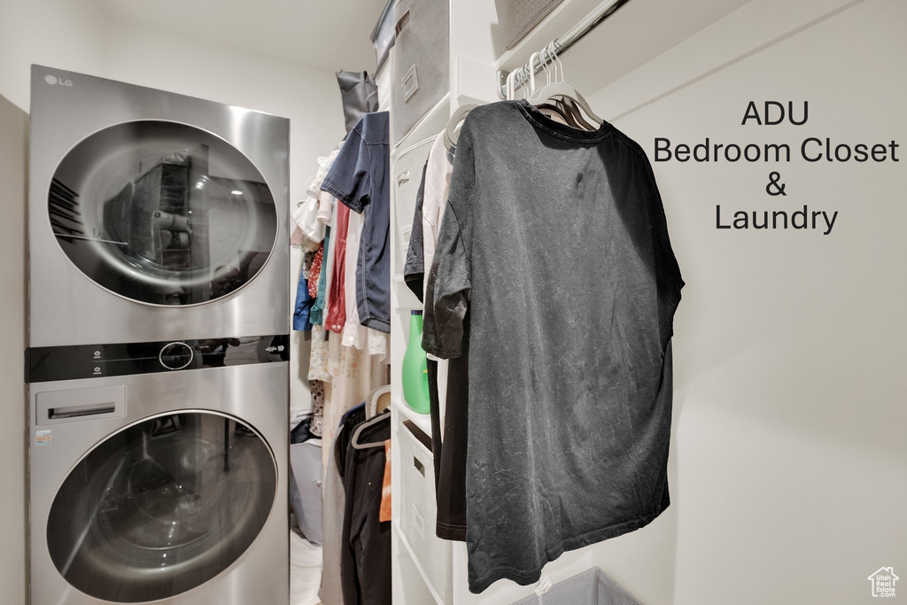 Laundry area with stacked washer and clothes dryer