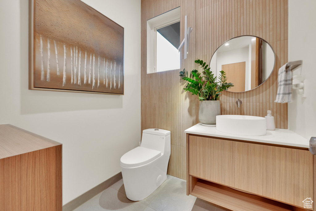 Bathroom featuring vanity and decorative backsplash