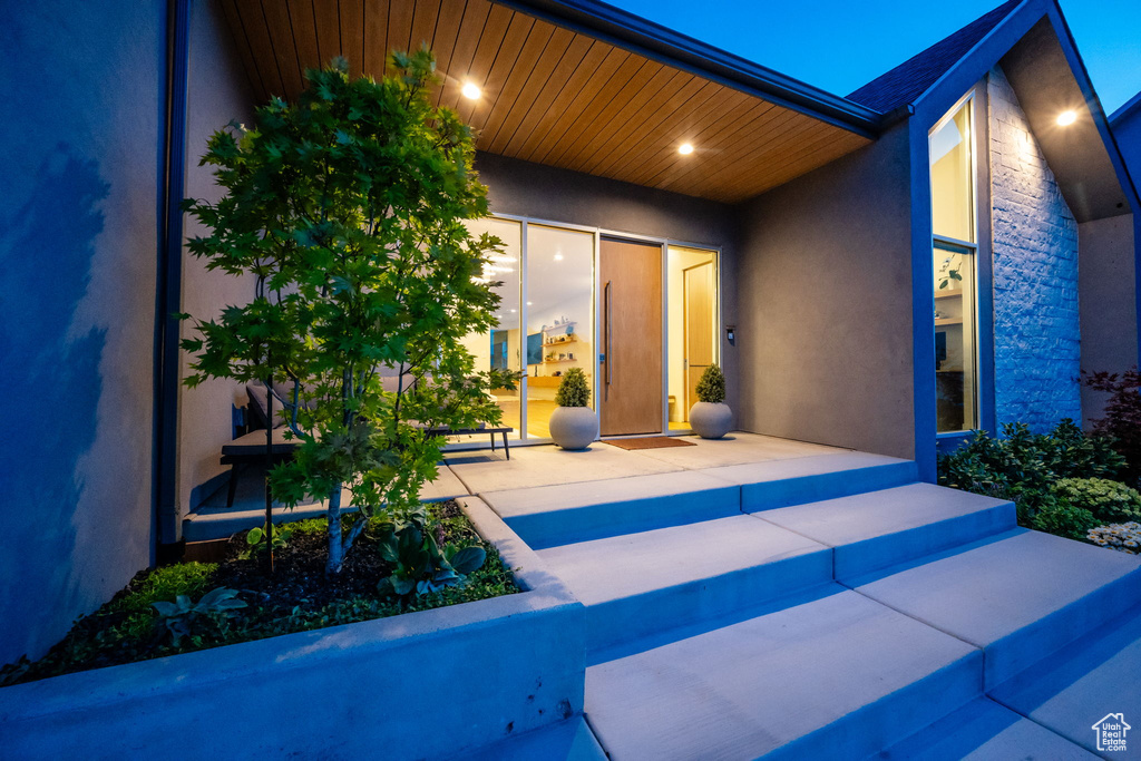 Entrance to property with stucco siding