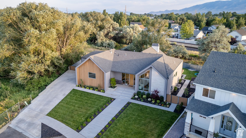 Aerial view of property and surrounding area featuring a mountain backdrop