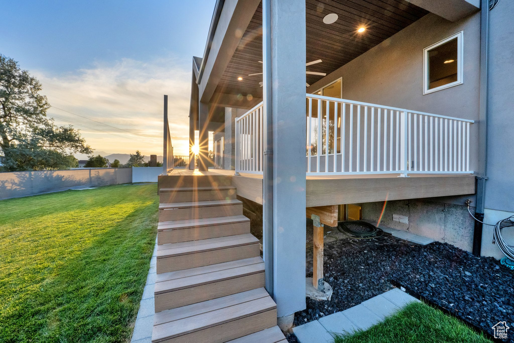 Property exterior at dusk featuring stairs and stucco siding