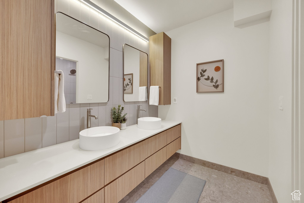 Full bathroom featuring backsplash and double vanity
