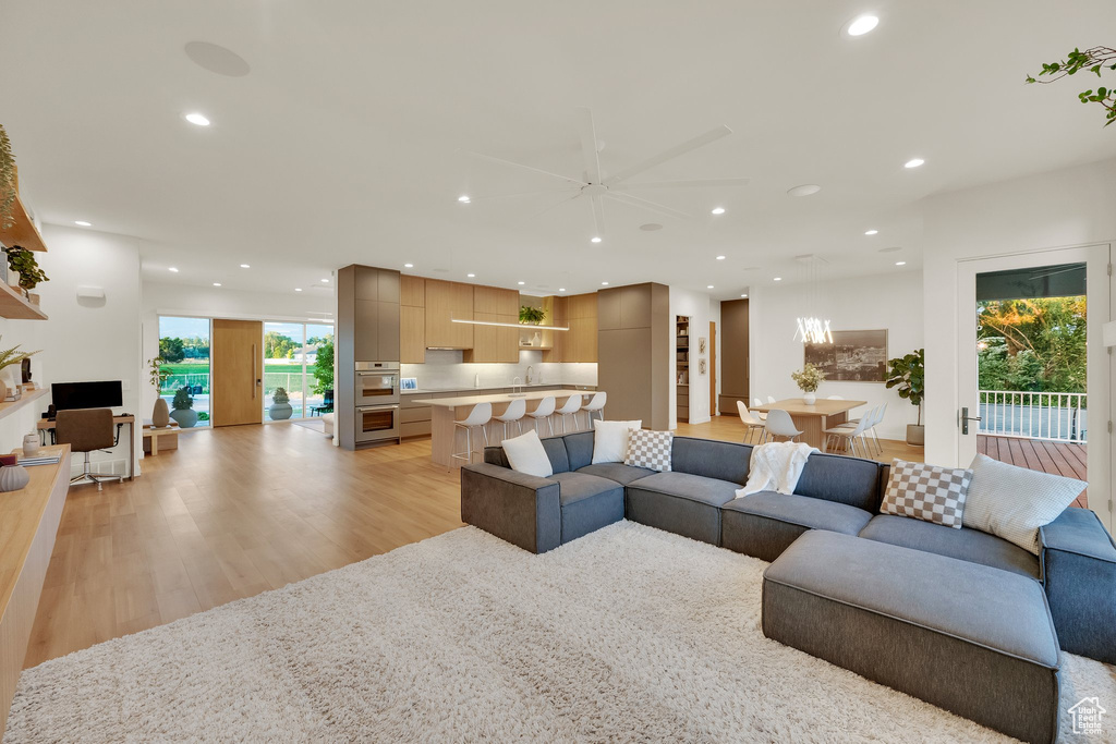 Living area featuring recessed lighting, light wood-style flooring, and ceiling fan