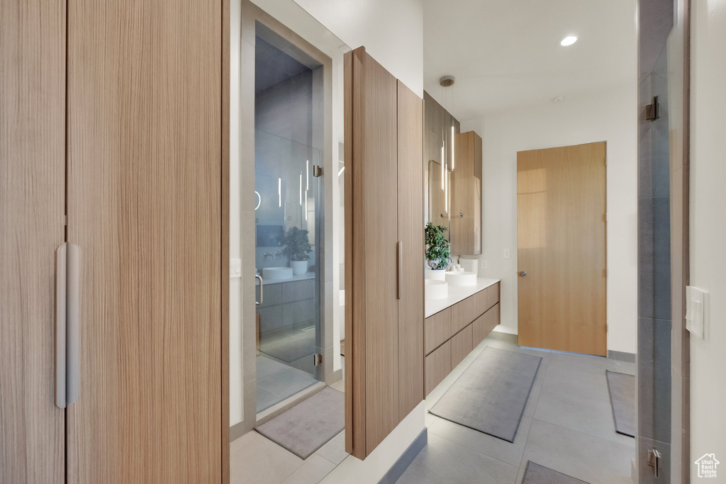 Full bathroom featuring vanity and tile patterned flooring