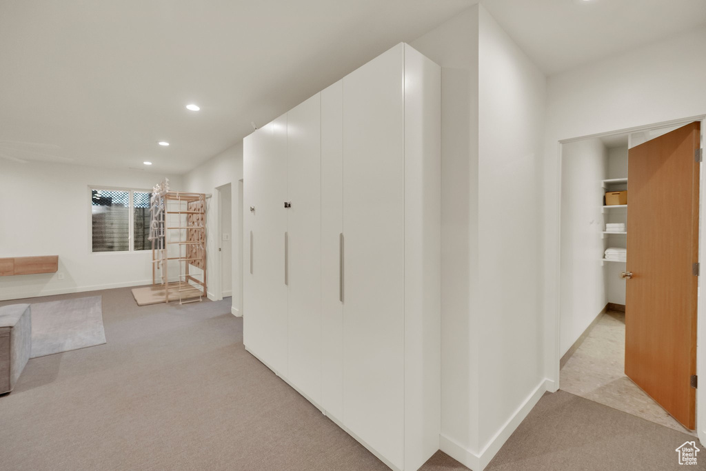 Hallway featuring light carpet and recessed lighting