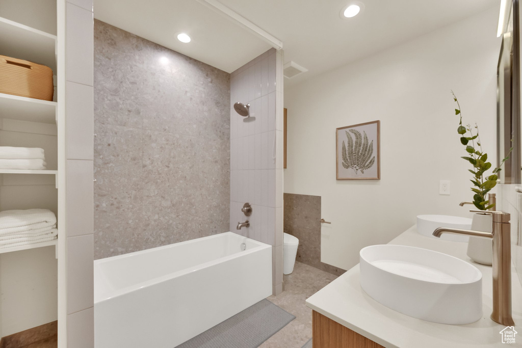 Bathroom with shower / bath combination, double vanity, and recessed lighting