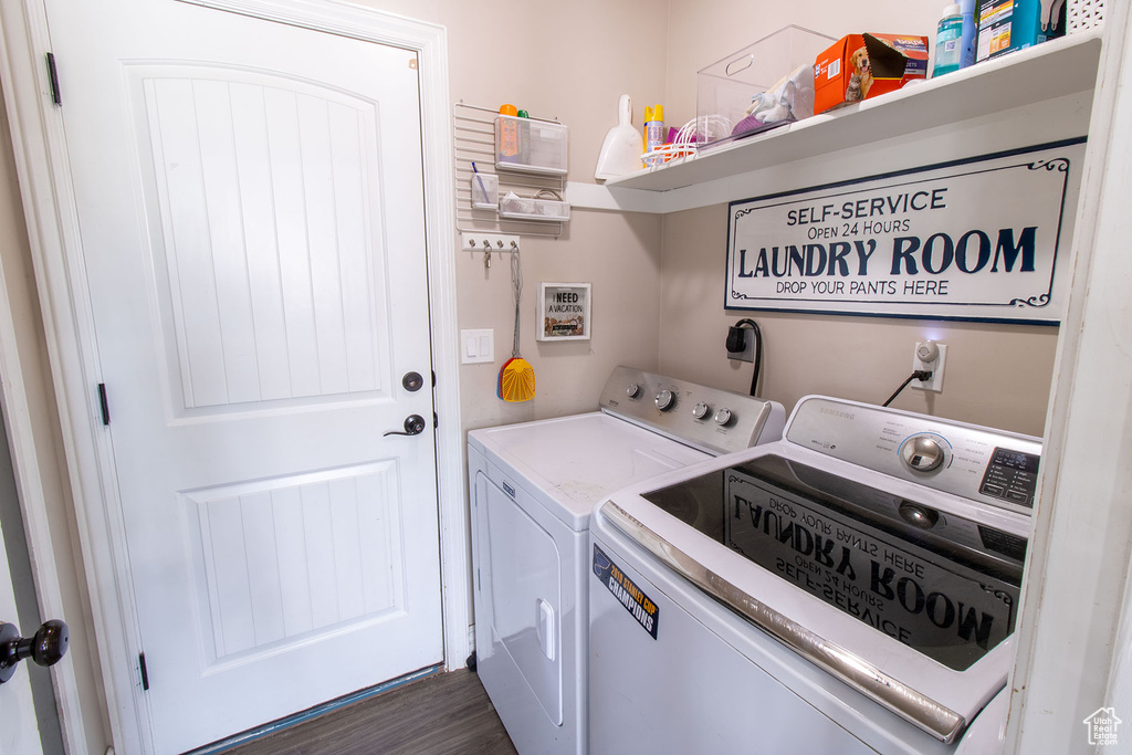 Laundry area featuring washer and clothes dryer and dark wood-type flooring