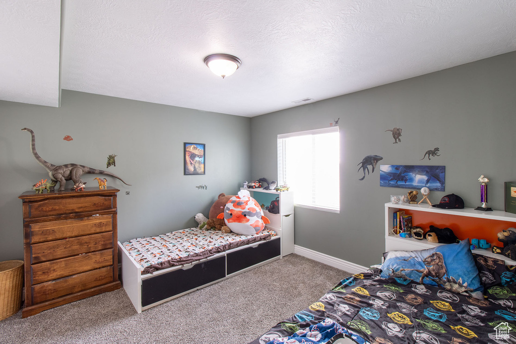 Carpeted bedroom featuring baseboards