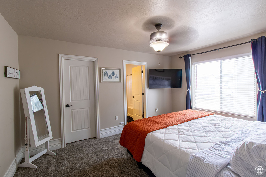Carpeted bedroom featuring a textured ceiling