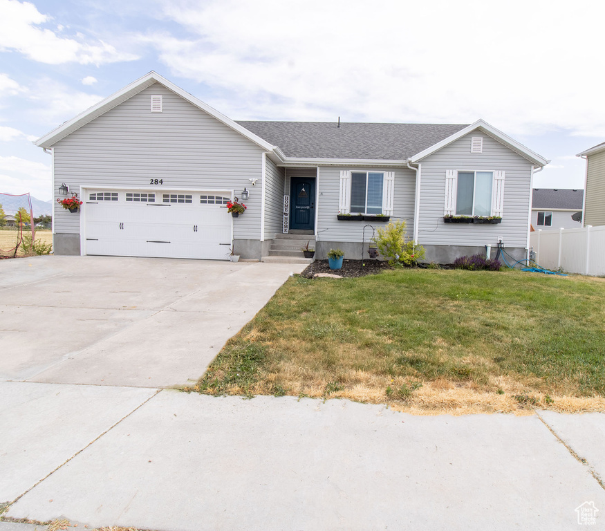 Ranch-style house with concrete driveway and a garage