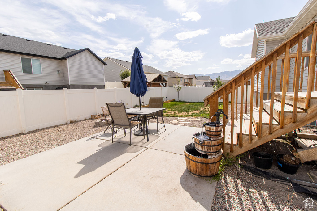 Fenced backyard with outdoor dining area, a patio area, and a residential view