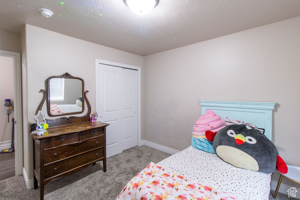 Bedroom featuring carpet and baseboards