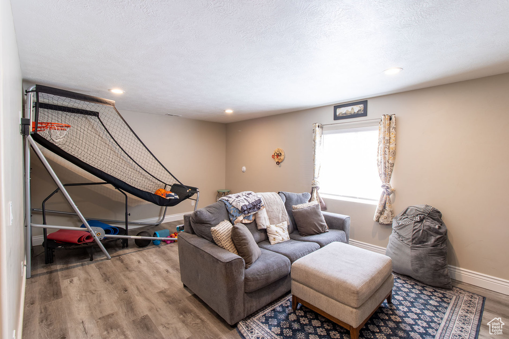 Living room with wood finished floors and recessed lighting