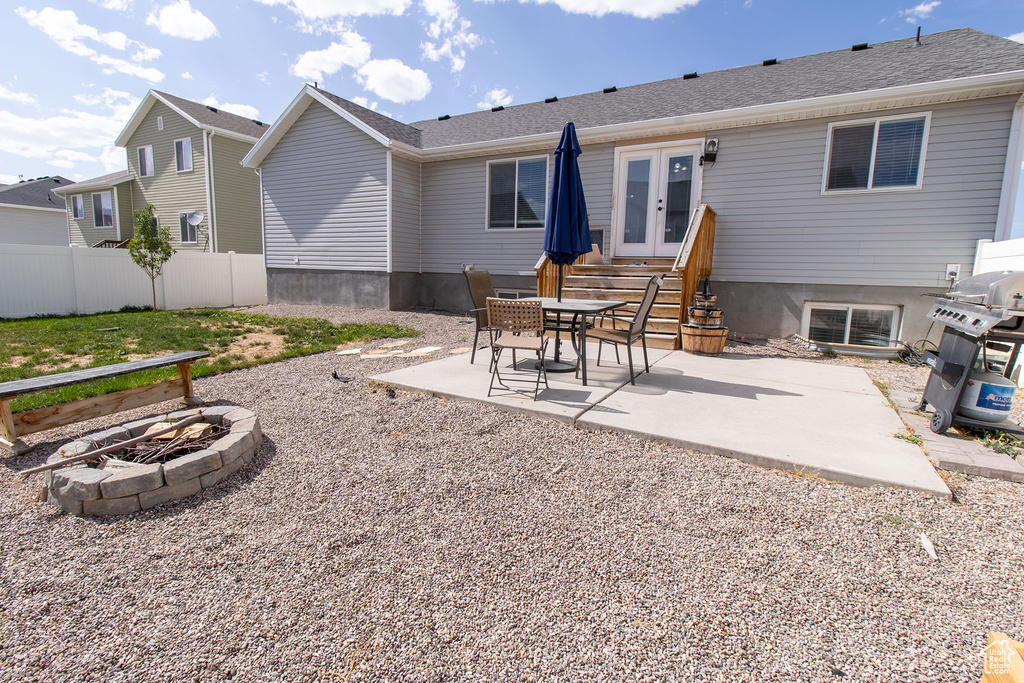 Back of house featuring an outdoor fire pit, french doors, and a patio area