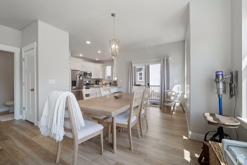 Dining area featuring light wood-style floors, a chandelier, and recessed lighting