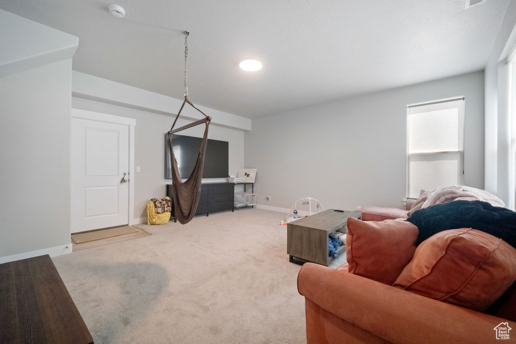 Living area featuring light colored carpet and recessed lighting