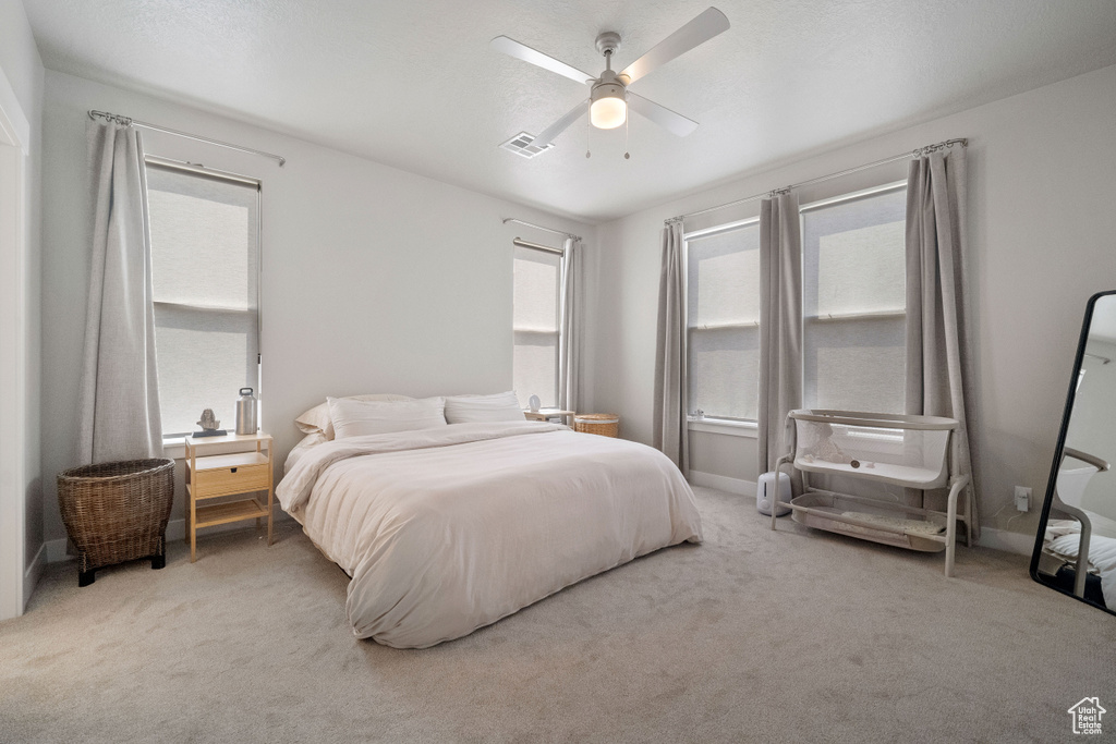 Carpeted bedroom with ceiling fan