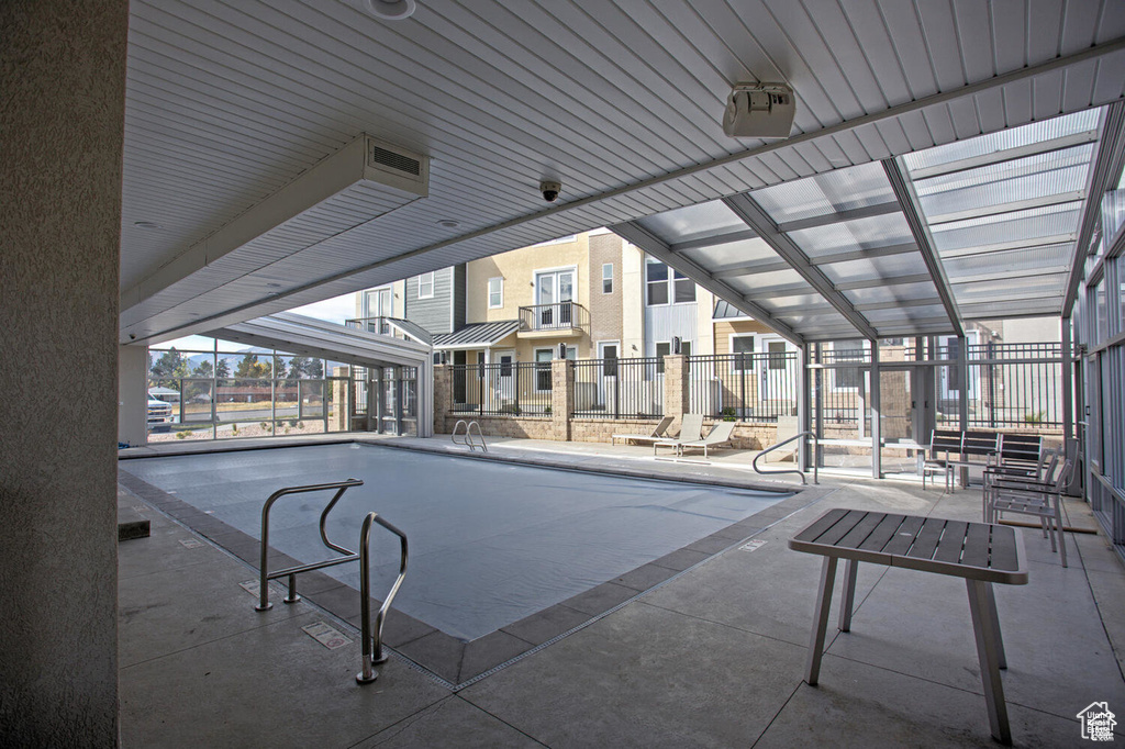Indoor community pool featuring a patio area