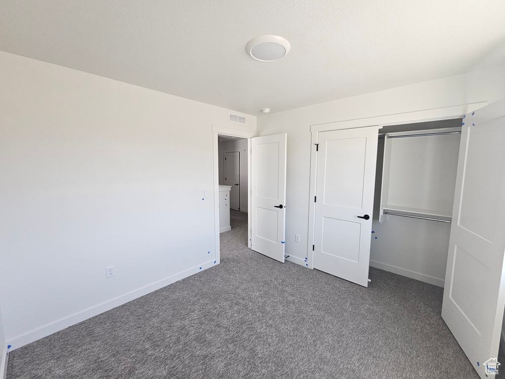 Unfurnished bedroom with carpet floors and a closet