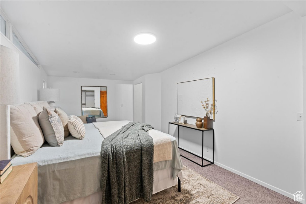 Carpeted bedroom featuring baseboards
