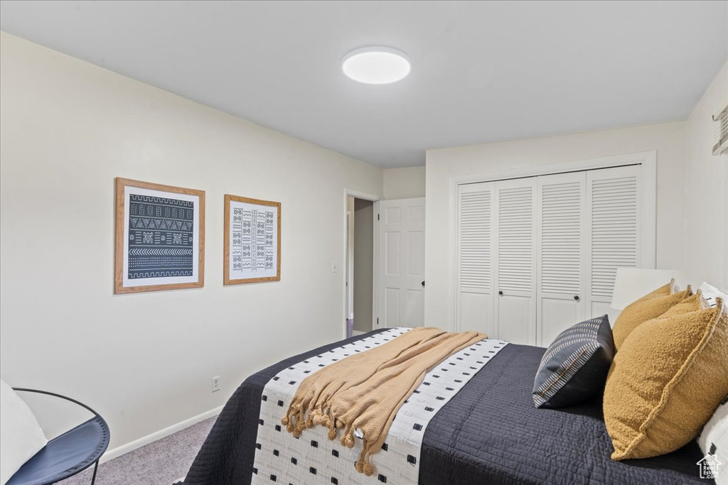 Bedroom featuring carpet and a closet