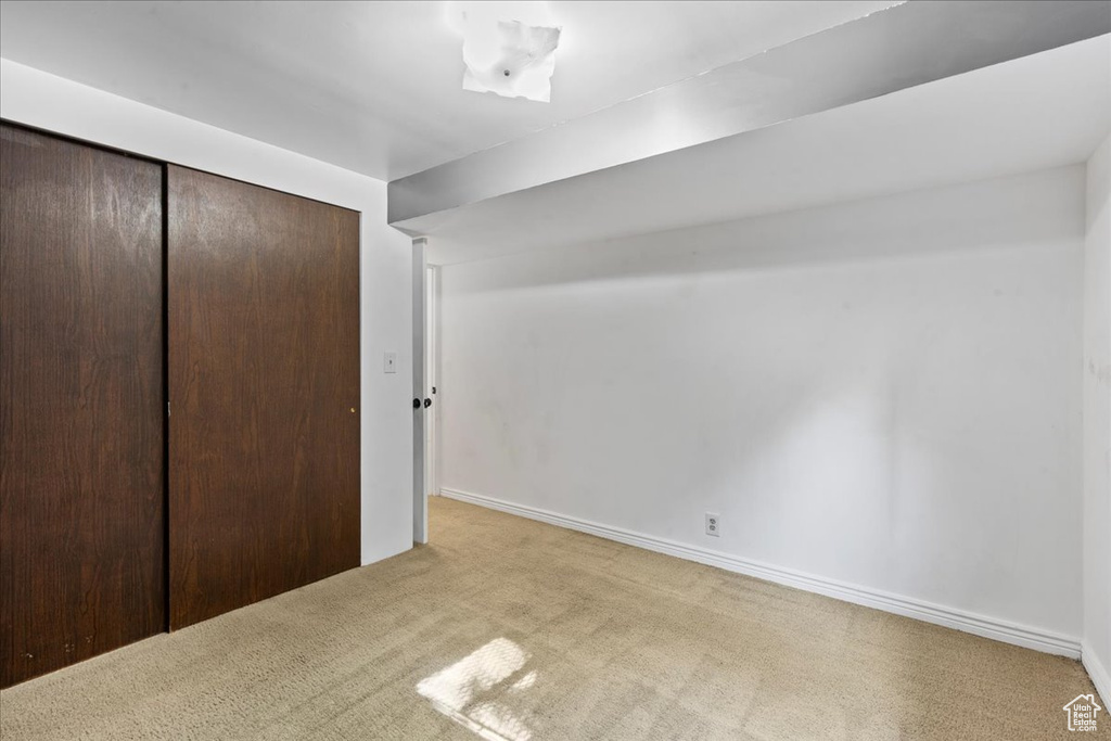 Unfurnished bedroom with carpet flooring and a closet