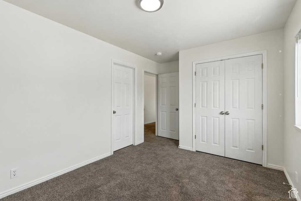 Unfurnished bedroom featuring carpet floors and a closet