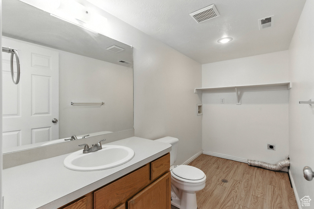 Bathroom with wood finished floors and vanity