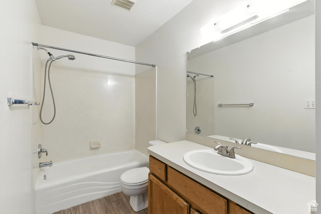 Full bathroom featuring shower / bathtub combination, vanity, and wood finished floors