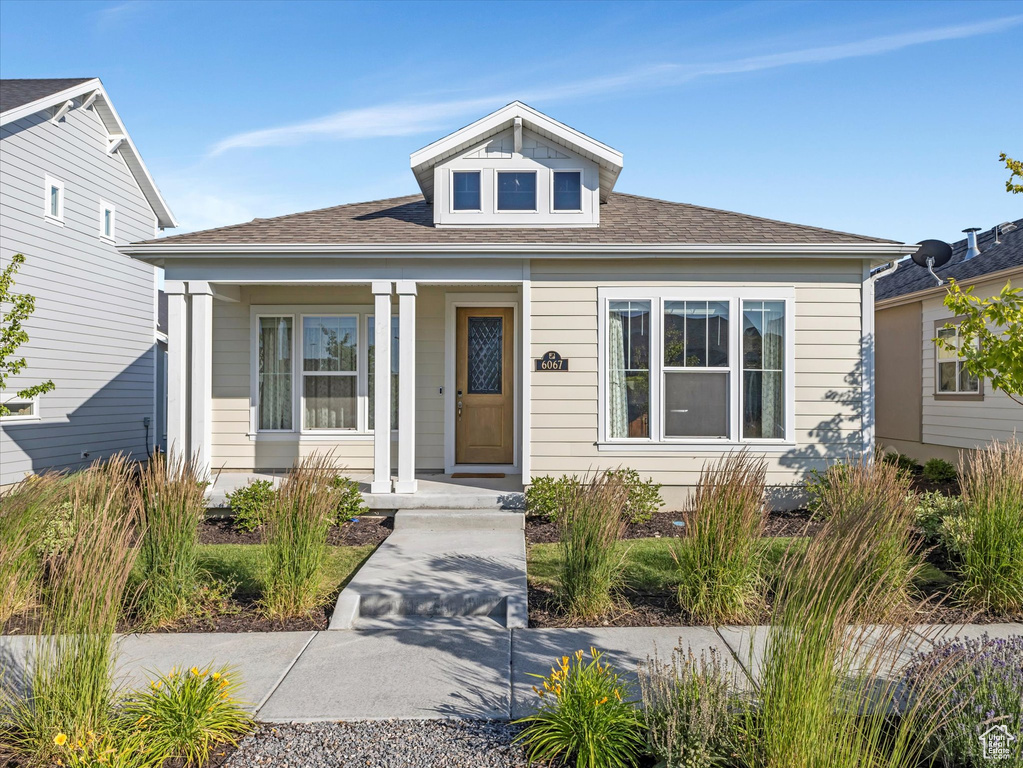 Bungalow-style house with a porch and roof with shingles