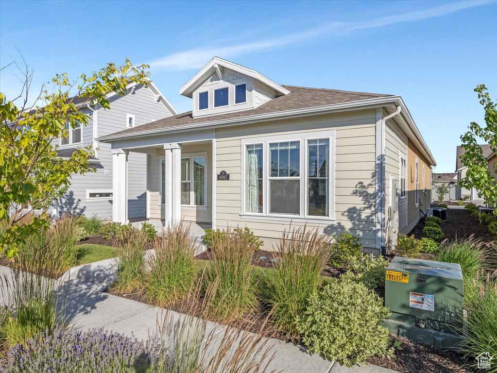 Bungalow-style house featuring a porch and a shingled roof