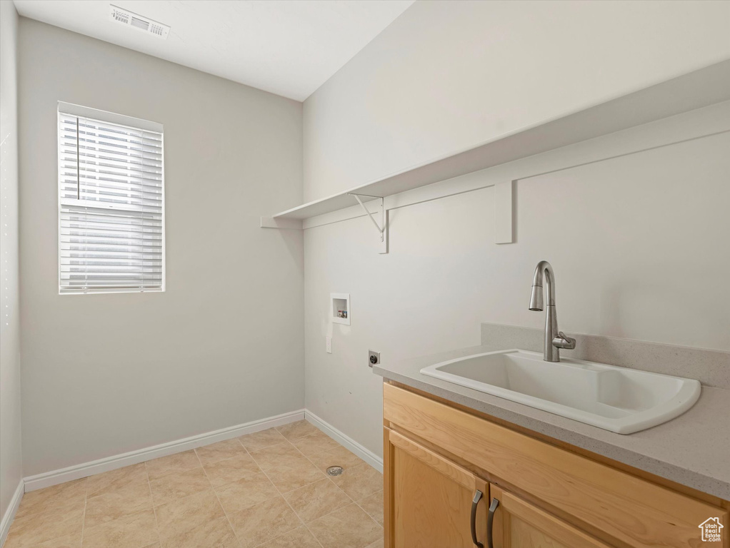 Laundry area featuring electric dryer hookup, washer hookup, and cabinet space