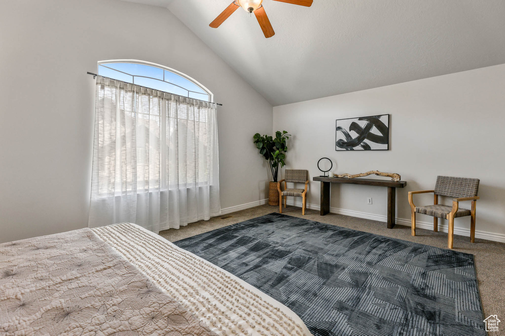 Bedroom featuring carpet flooring, vaulted ceiling, and a ceiling fan