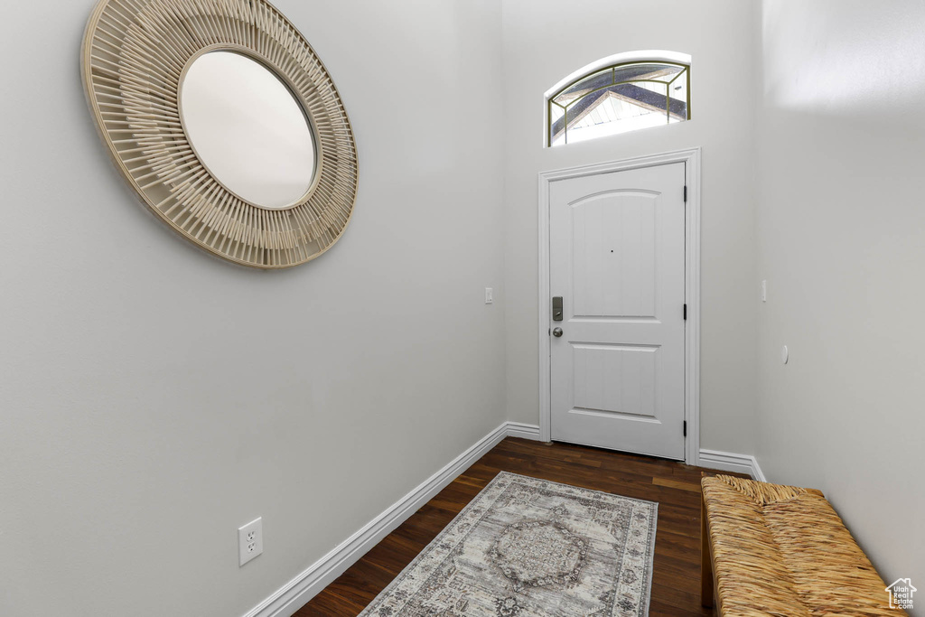 Foyer featuring dark wood-type flooring and baseboards