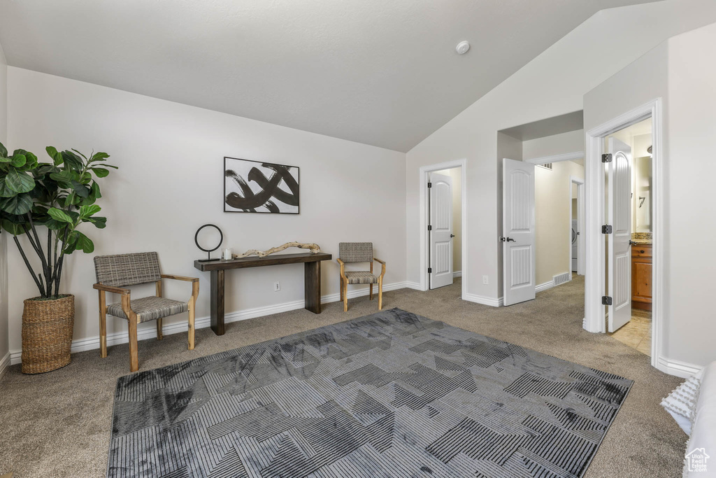 Sitting room with carpet floors and vaulted ceiling